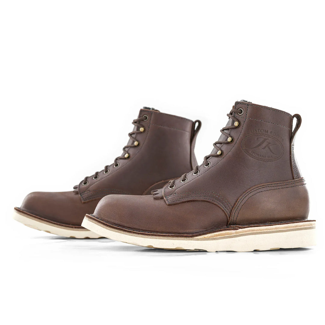 Side view of a pair of Forefront Brown leather work boots on a white background