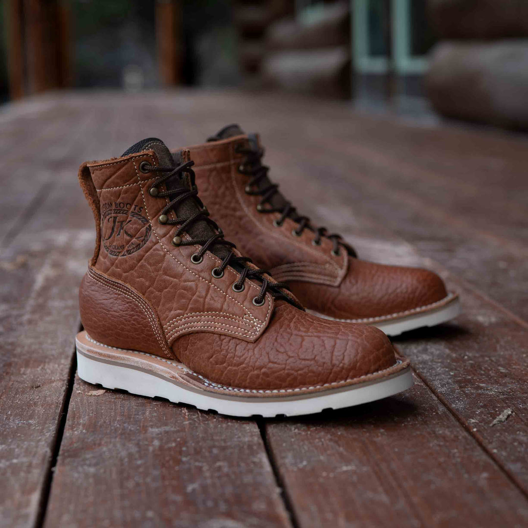 Pair of Forefront Canyon Bison leather work boots on a house porch