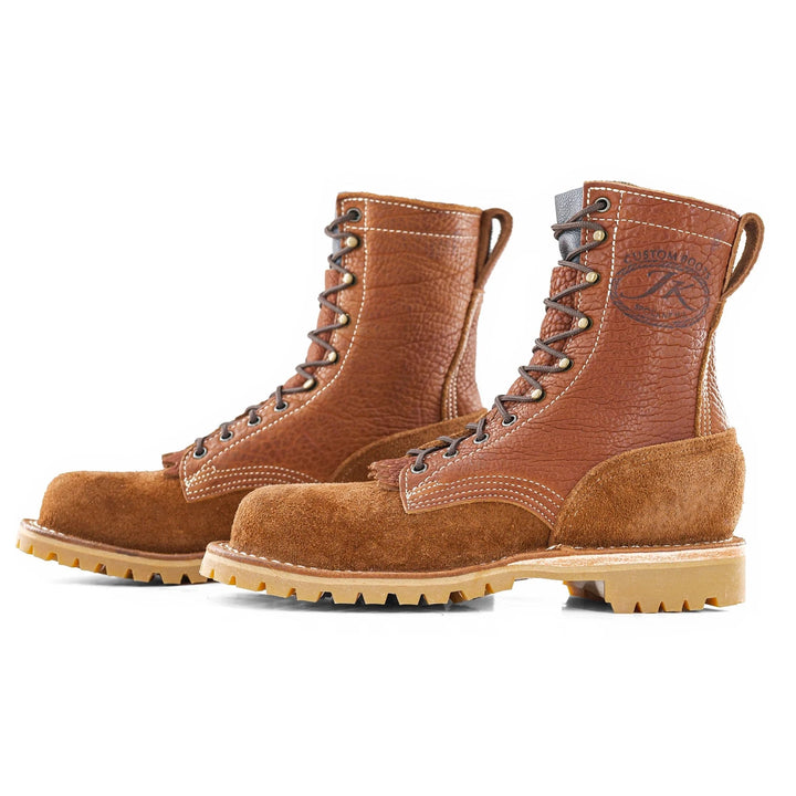 Side view of a pair of OT Canyon Bison rough leather work boots on a white background