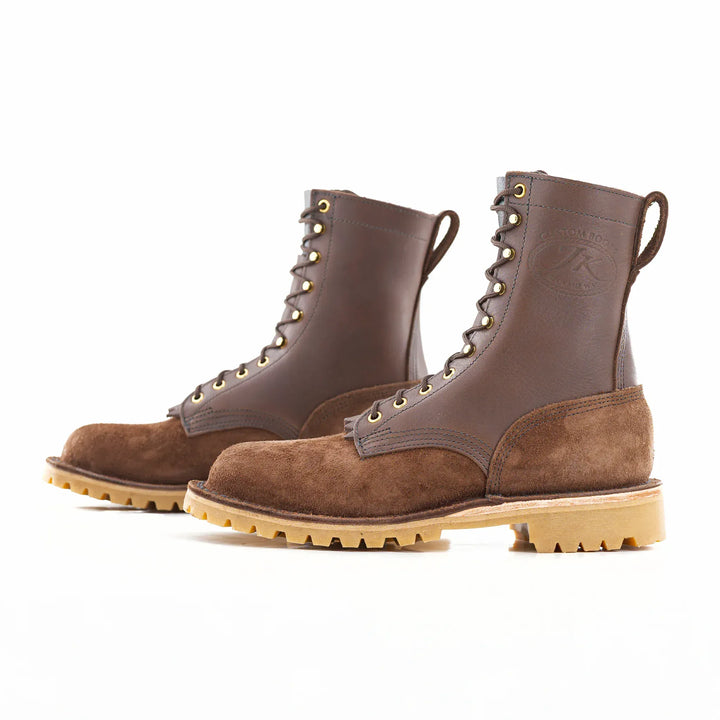 Side view of a pair of OT Brown rough leather work boots on a white background