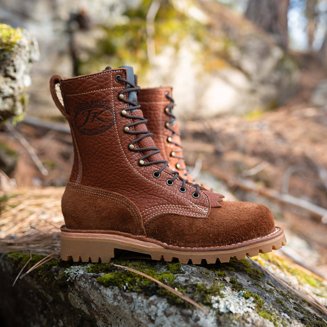 Pair of OT Canyon Bison leather work boots on a rock in a natural setting