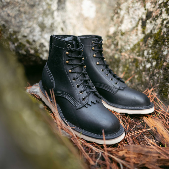 Pair of Forefront black leather work boots on a natural background