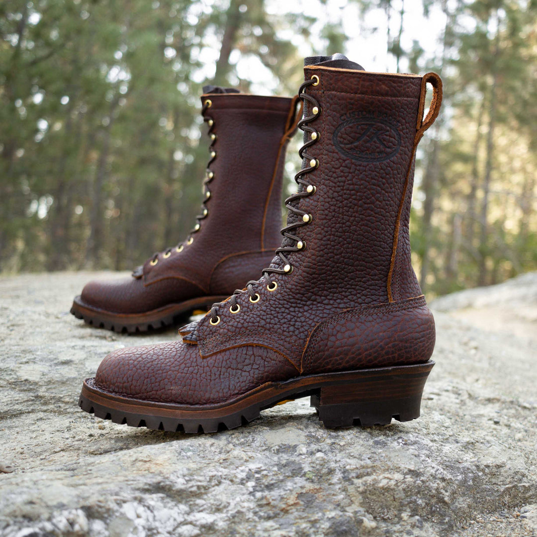 Side view of a pair of Superduty Bison leather work boots on a rock