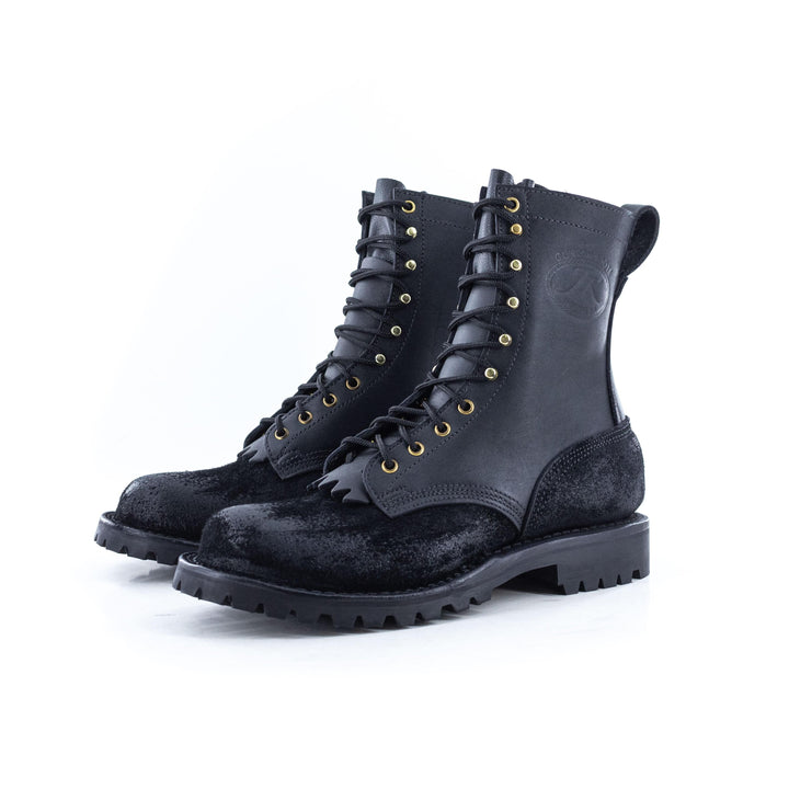 Side view of a pair of OT Pro Black leather work boots on a white background