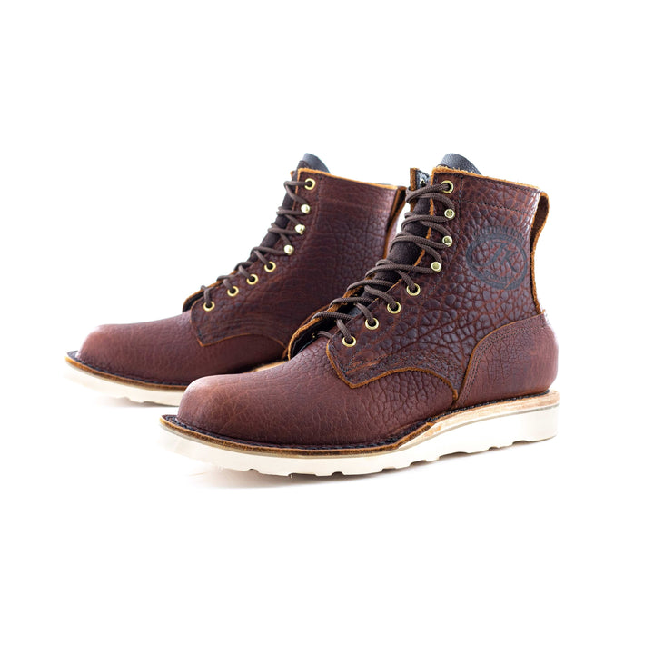 Side view of a pair of Forefront Bison leather work boots on a white background