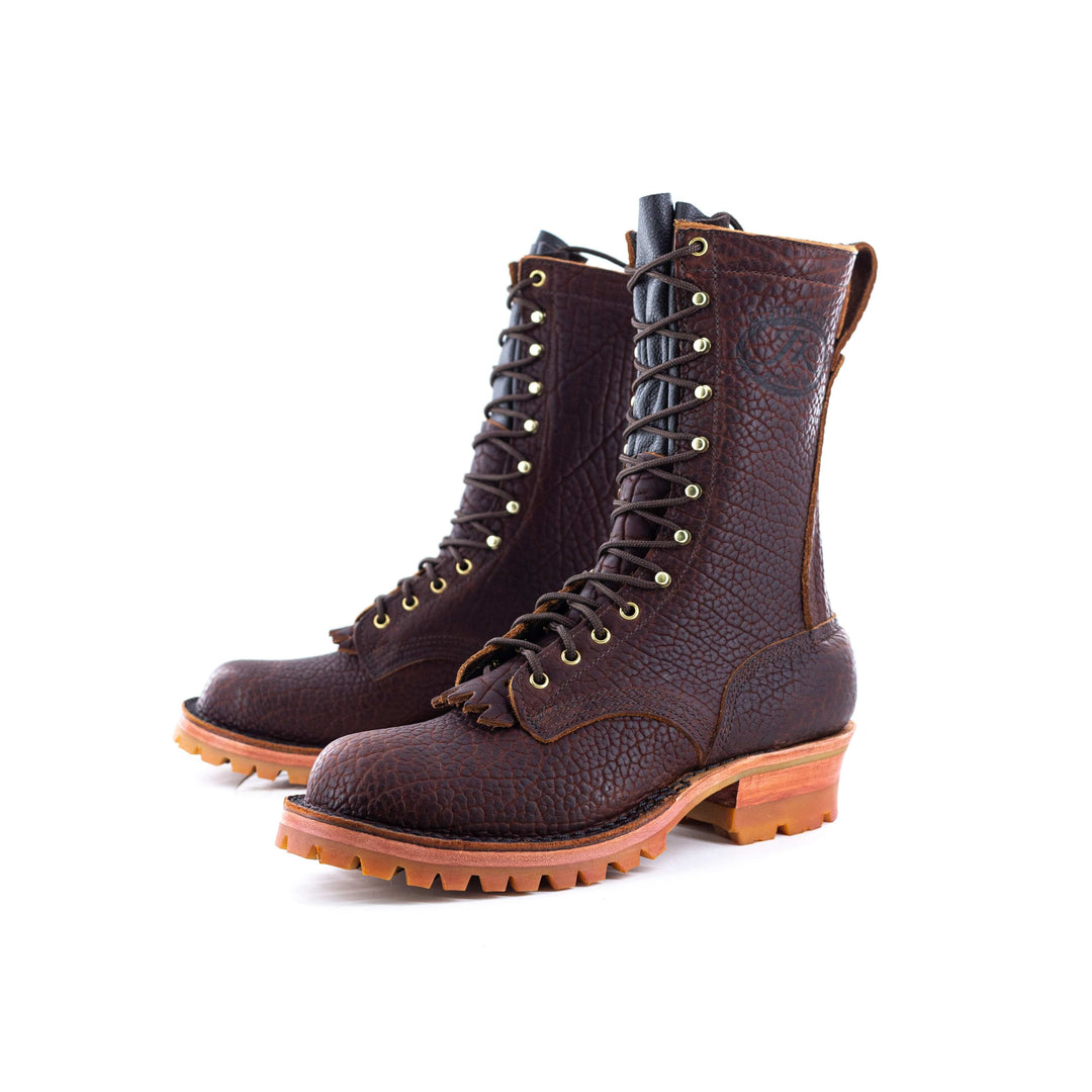 Side view of a pair Honey Bison leather work boots on a white background