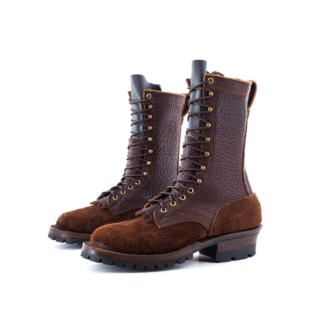 Side view of a pair of Superduty Bison rough leather work boots on a white background