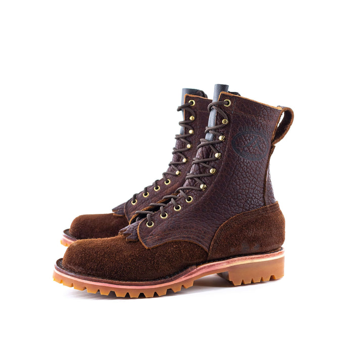Side view of a pair of OT Bison rough leather work boots on a white background